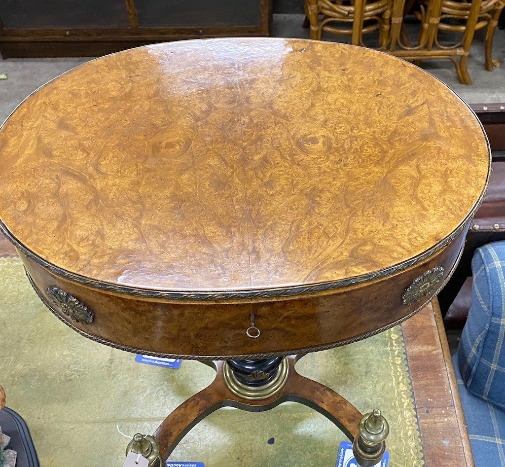 An early 20th century French gilt metal mounted part ebonised bird's eye maple oval work table, width 55cm, depth 39cm, height 74cm